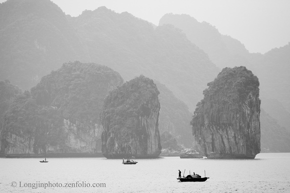 Fisherman in the mist - Halong Bay