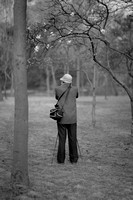 man photographing magnolias